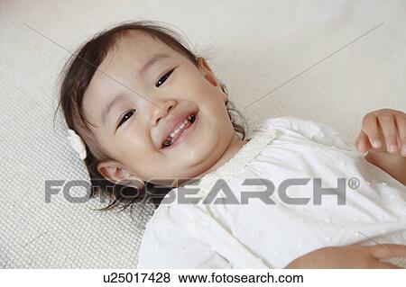 Japanese Baby Girl Laying on Floor View Large Photo Image Stock Photo - Japanese Baby Girl Laying on Floor. Fotosearch