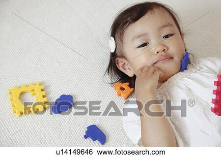 Japanese Baby Girl Laying on Floor View Large Photo Image Stock Photograph - Japanese Baby Girl Laying on Floor. Fotosearch