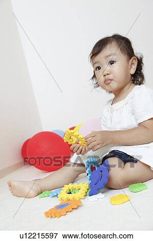 Stock Photo - Japanese Baby Girl Playing with Toys. Fotosearch