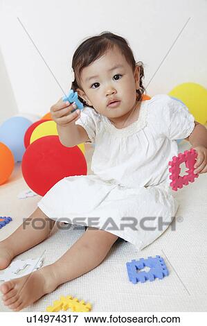 Stock Photo - Japanese Baby Girl Playing with Toys. Fotosearch