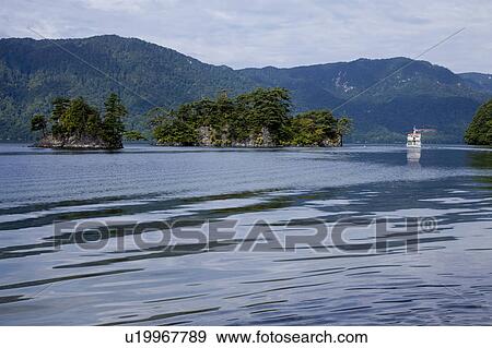 Stock Photo - Lake Towada and Sightseeing boat. Fotosearch