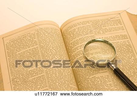 Stock Photo - Magnifying Glass on Book. Fotosearch