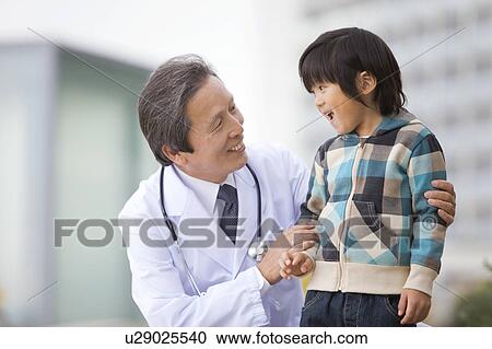 Stock Image - Male Doctor and Boy. Fotosearch