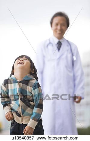 Stock Photo - Male Doctor and Boy. Fotosearch