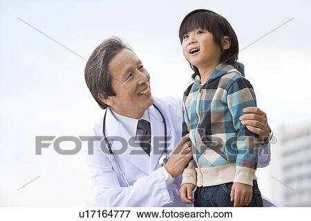 Stock Photo - Male Doctor and Boy. Fotosearch