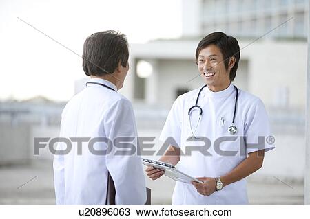 Male Doctor and Nurse Discussing View Large Photo Image Stock Image - Male Doctor and Nurse Discussing. Fotosearch