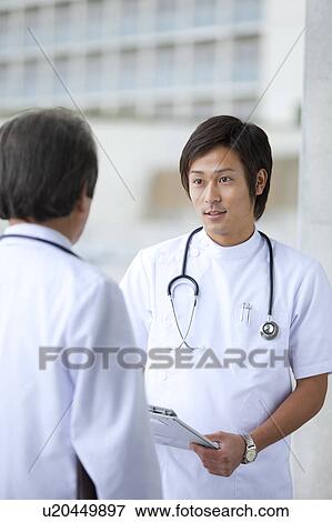 Male Doctor and Nurse Discussing View Large Photo Image Stock Photo - Male Doctor and Nurse Discussing. Fotosearch