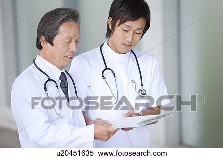 Male Doctor and Nurse Discussing View Large Photo Image Stock Photography - Male Doctor and Nurse Discussing. Fotosearch