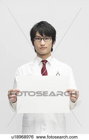 Stock Photograph - Male Doctor Showing Blank Message. Fotosearch