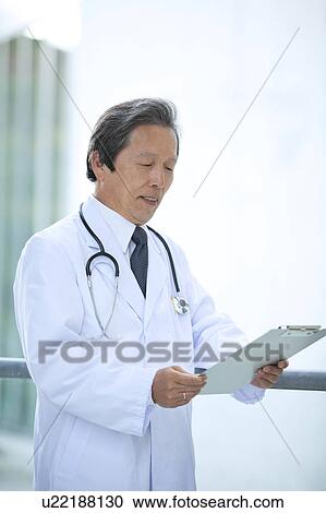 Male Doctor with Clipboard View Large Photo Image Stock Image - Male Doctor with Clipboard. Fotosearch