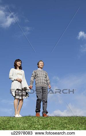 Stock Image - Mature Couple Against Blue Sky. Fotosearch