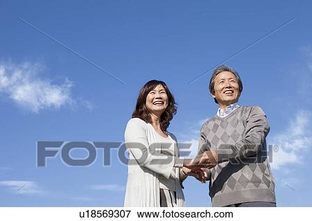 Mature Couple Against Blue Sky View Large Photo Image Stock Photo - Mature Couple Against Blue Sky. Fotosearch