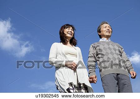 Stock Photography - Mature Couple Against Blue Sky. Fotosearch