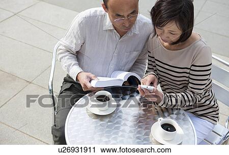 Mature couple having coffee outdoors View Large Photo Image Stock Image - Mature couple having coffee outdoors. Fotosearch
