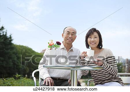 Mature couple having tea outdoors View Large Photo Image Stock Photo - Mature couple having tea outdoors. Fotosearch