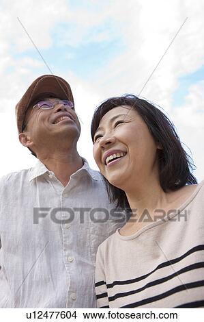 Mature couple looking up View Large Photo Image Picture - Mature couple looking up. Fotosearch