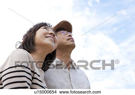 Picture - Mature couple looking up. Fotosearch