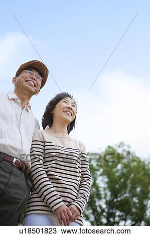 Stock Image - Mature couple looking up. Fotosearch