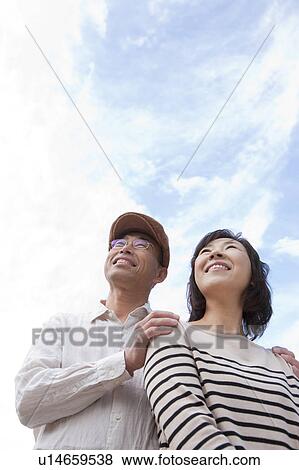Stock Photo - Mature couple looking up. Fotosearch