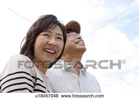Stock Photo - Mature couple looking up. Fotosearch