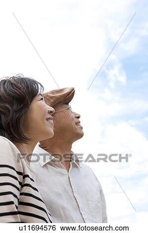 Stock Photograph - Mature couple looking up. Fotosearch