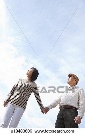 Stock Photograph - Mature couple looking up. Fotosearch