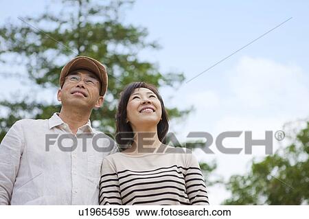 Stock Photography - Mature couple looking up. Fotosearch
