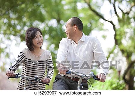 Mature couple riding bicycle View Large Photo Image Stock Photo - Mature couple riding bicycle. Fotosearch