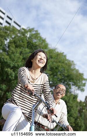 Mature couple riding bicycle View Large Photo Image Stock Photography - Mature couple riding bicycle. Fotosearch