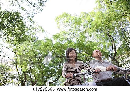 Stock Photography - Mature couple riding bicycle. Fotosearch