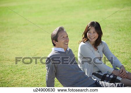 Mature Couple Sitting on Grass View Large Photo Image Stock Image - Mature Couple Sitting on Grass. Fotosearch