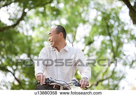 Mature man riding a bicycle View Large Photo Image Stock Photo - Mature man riding a bicycle. Fotosearch