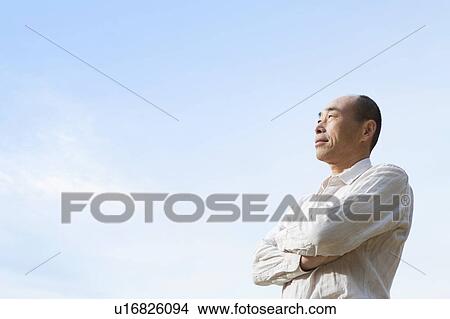 Picture - Mature man standing outdoors. Fotosearch