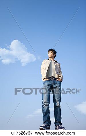 Mid Adult Man Against Blue Sky View Large Photo Image Stock Photo - Mid Adult Man Against Blue Sky. Fotosearch