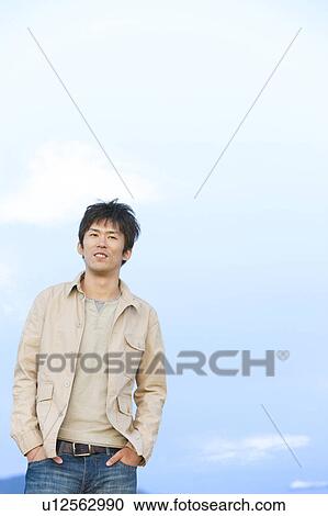 Stock Image - Mid Adult Man Against Sky. Fotosearch