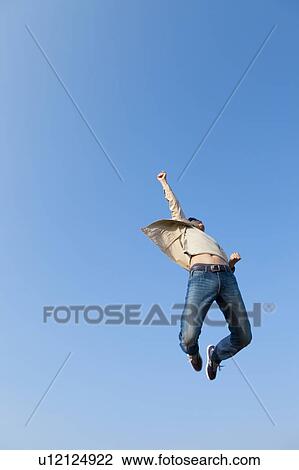 Stock Image - Mid Adult Man Jumping. Fotosearch