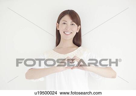 Mid Adult Woman Forming Heart Shape with Fingers View Large Photo Image Picture - Mid Adult Woman Forming Heart Shape with Fingers. Fotosearch