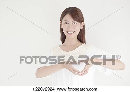 Mid Adult Woman Forming Heart Shape with Fingers View Large Photo Image Picture - Mid Adult Woman Forming Heart Shape with Fingers. Fotosearch