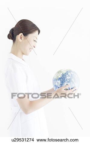 Mid Adult Woman Holding Globe View Large Photo Image Picture - Mid Adult Woman Holding Globe. Fotosearch