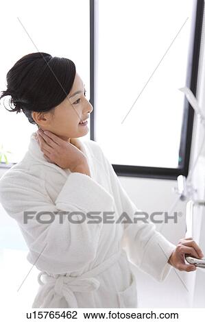 Stock Image - Mid Adult Woman in Bathroom. Fotosearch