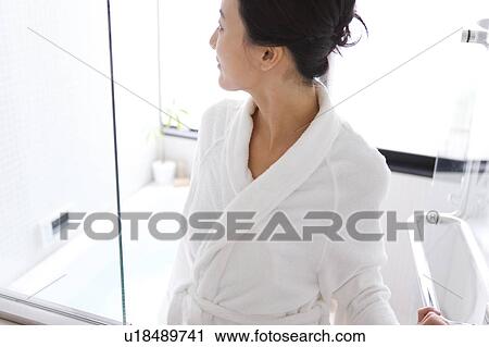 Stock Image - Mid Adult Woman in Bathroom. Fotosearch