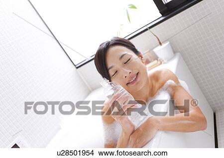 Picture - Mid Adult Woman with Eyes Closed in Bath. Fotosearch