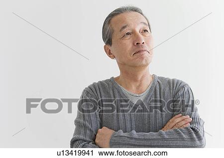 Stock Image - Middle-aged Man with Arms Crossed. Fotosearch