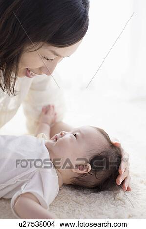 Mother and baby looking at each other View Large Photo Image Picture - Mother and baby looking at each other. Fotosearch