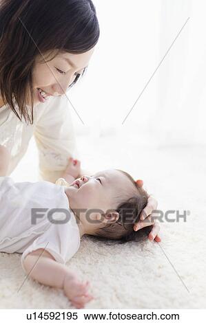 Mother and baby looking at each other View Large Photo Image Stock Photography - Mother and baby looking at each other. Fotosearch