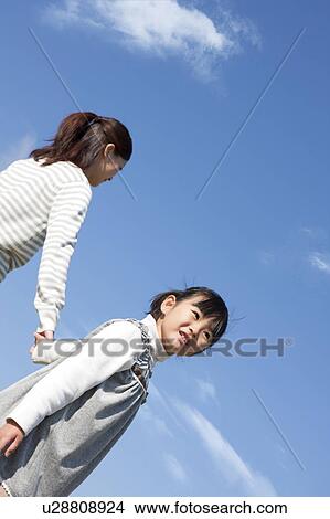 Mother and Daughter Against Blue Sky View Large Photo Image Picture - Mother and Daughter Against Blue Sky. Fotosearch