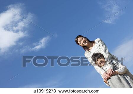 Mother and Daughter Against Blue Sky View Large Photo Image Stock Image - Mother and Daughter Against Blue Sky. Fotosearch