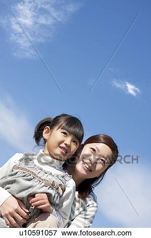 Mother and Daughter Against Blue Sky View Large Photo Image Stock Photo - Mother and Daughter Against Blue Sky. Fotosearch
