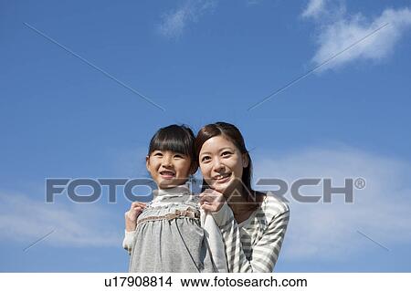 Mother and Daughter Against Sky View Large Photo Image Picture - Mother and Daughter Against Sky. Fotosearch