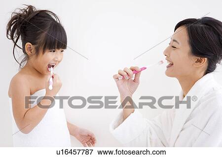 Mother and daughter brushing teeth View Large Photo Image Stock Photo - Mother and daughter brushing teeth. Fotosearch